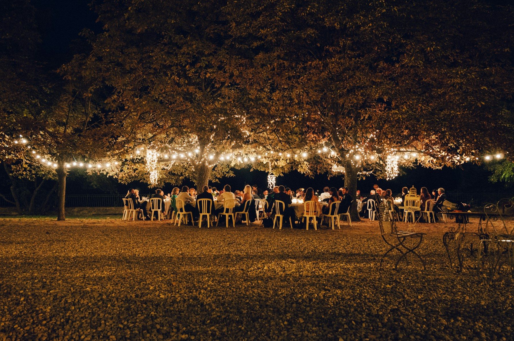 Communal dinner table in a productive garden at dusk